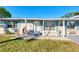 Inviting front porch with blue shutters and a welcoming entrance at 824 E 6Th St, Englewood, FL 34223
