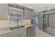 Kitchen with gray cabinets, granite counters, and a view to the canal at 824 E 6Th St, Englewood, FL 34223