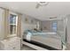 Main bedroom with king bed, ceiling fan, and access to en-suite bathroom at 824 E 6Th St, Englewood, FL 34223