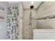 Walk-in shower with tile surround and pebble floor at 824 E 6Th St, Englewood, FL 34223