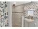 Walk-in shower with tile surround and pebble floor at 824 E 6Th St, Englewood, FL 34223