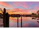 Beautiful sunset reflected in calm canal waters at 128 Great Isaac Ct, Punta Gorda, FL 33950