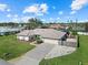 Aerial view of single-story home with fenced backyard, driveway, and lush lawn at 1324 De Prie Rd, Englewood, FL 34223