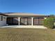 Home exterior showcasing a large backyard and patio at 13523 Drysdale Ave, Port Charlotte, FL 33981