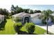 Single-story house with a spacious lawn and palm trees at 1436 Hedgewood Cir, North Port, FL 34288