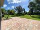 Private patio with brick pavers and backyard view at 1436 Hedgewood Cir, North Port, FL 34288