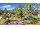 An aerial view of a property with a shed and various trees at 14454 Nw Chamberlain Blvd, Port Charlotte, FL 33953