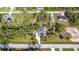Aerial view of a house with a pool, showcasing its surroundings at 14454 Nw Chamberlain Blvd, Port Charlotte, FL 33953