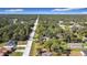 Wide aerial view of a neighborhood with lush vegetation at 14454 Nw Chamberlain Blvd, Port Charlotte, FL 33953