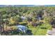 An aerial view showcasing a house with a shed in a wooded area at 14454 Nw Chamberlain Blvd, Port Charlotte, FL 33953