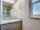 Bathroom with granite countertop vanity and large mirror at 14454 Nw Chamberlain Blvd, Port Charlotte, FL 33953