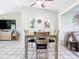 Bright dining area with grey table and four chairs, open to living area at 14454 Nw Chamberlain Blvd, Port Charlotte, FL 33953