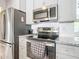 Stainless steel appliances and granite countertops in this modern kitchen at 14454 Nw Chamberlain Blvd, Port Charlotte, FL 33953