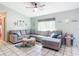 Spacious living room featuring a comfy sectional sofa and tiled floors at 14454 Nw Chamberlain Blvd, Port Charlotte, FL 33953