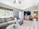 Open living area with sectional sofa and view into kitchen and laundry room at 14454 Nw Chamberlain Blvd, Port Charlotte, FL 33953