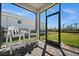 Screened porch with patio furniture and backyard view at 16689 Expedition Ct, Punta Gorda, FL 33982