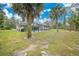 Spacious backyard with a lush lawn and mature trees at 18340 Laramie Ave, Port Charlotte, FL 33954