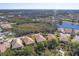 Aerial view of community, showcasing homes, lake, and surrounding landscape at 1861 San Trovaso Way, Venice, FL 34285