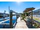 Private wooden boat dock with covered seating area at 18614 Kerrville Cir, Port Charlotte, FL 33948