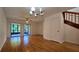 Living room with laminate floors, patio access, and staircase at 2000 Forrest Nelson Blvd # C8, Port Charlotte, FL 33952