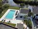 Community pool with patio furniture and lush landscaping at 2000 Forrest Nelson Blvd # C8, Port Charlotte, FL 33952