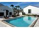 Community pool with surrounding patio furniture and landscaping at 2000 Forrest Nelson Blvd # C8, Port Charlotte, FL 33952
