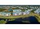 Aerial view highlighting condo building near lake and other buildings at 2120 Heron Lake Dr # 107, Punta Gorda, FL 33983