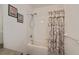 Bathroom with floral shower curtain and bathtub at 2160 Heron Lake Dr # 104, Port Charlotte, FL 33983