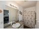Bathroom with floral shower curtain and single sink vanity at 2160 Heron Lake Dr # 104, Port Charlotte, FL 33983