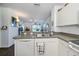 Kitchen with double sink, dishwasher and view into the living room at 2160 Heron Lake Dr # 104, Port Charlotte, FL 33983