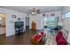 Living room features a ceiling fan, and access to a patio overlooking water at 2160 Heron Lake Dr # 104, Port Charlotte, FL 33983