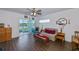 Living room with wood floors, sofa, and view of screened porch at 2160 Heron Lake Dr # 104, Port Charlotte, FL 33983