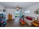 Living room with wood-look floors, sliding glass doors, and comfy seating at 2160 Heron Lake Dr # 104, Port Charlotte, FL 33983
