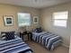 Bedroom with twin beds and nautical-themed bedding at 2179 Lakeshore Cir, Port Charlotte, FL 33952