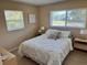 Well-lit bedroom with a comfortable queen bed and ample natural light at 2179 Lakeshore Cir, Port Charlotte, FL 33952