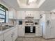 Kitchen with white cabinets and tiled backsplash at 2395 Harbor Blvd # 301A, Port Charlotte, FL 33952