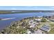 Aerial view of waterfront community with park, boat docks, and tennis courts at 27409 Voyageur Dr, Punta Gorda, FL 33983