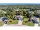 Aerial view of a house with a pool and landscaping in a residential neighborhood at 27486 Pasto Dr, Punta Gorda, FL 33983