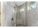 Large walk-in shower with stone tile and built-in seat at 27486 Pasto Dr, Punta Gorda, FL 33983