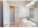 Bathroom with granite countertop, white cabinets, and a view of another room at 3087 Eagle Pass St, North Port, FL 34286