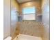 Bathroom with tile shower/tub combo and pebble tile accents at 3087 Eagle Pass St, North Port, FL 34286