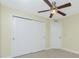 Well-lit bedroom featuring a ceiling fan and large closet at 3208 Congress St, North Port, FL 34288