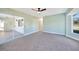 Bright bedroom with grey carpet and sliding glass doors at 3428 Tonkin Dr, North Port, FL 34287