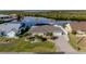 Property features a paved driveway and lush landscaping at 4195 Surfside Ct, Port Charlotte, FL 33948