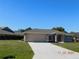 One-story home with attached garage, neutral color, and a well-maintained lawn at 53 Callao St, Punta Gorda, FL 33983