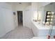 Bright bathroom with a vanity, large mirror, and access to other rooms at 546 Macedonia Dr, Punta Gorda, FL 33950