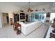 Bright living room featuring a white sectional sofa and built-in entertainment center at 546 Macedonia Dr, Punta Gorda, FL 33950