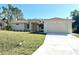 Newly constructed home with a two-car garage and a well-manicured lawn at 5986 Bobolink St, North Port, FL 34291