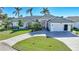 Beautiful home with a large driveway and mature landscaping at 809 Lucia Dr, Punta Gorda, FL 33950