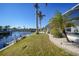 Landscaped backyard with lush grass and tropical plants at 809 Lucia Dr, Punta Gorda, FL 33950